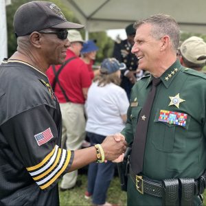 Sheriff Mina shaking hands with a civilian